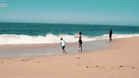 The children were playing by the sea