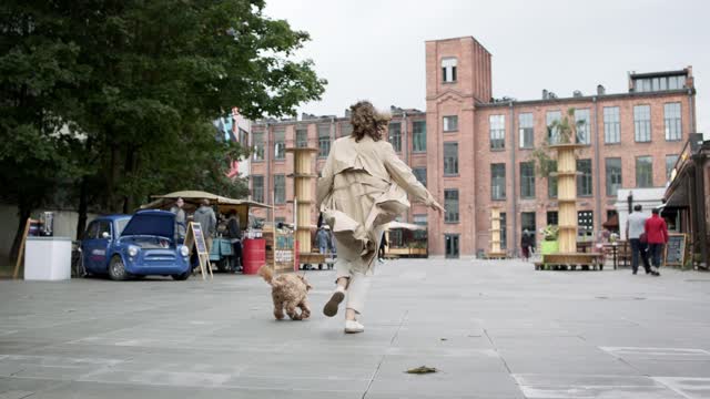 Young girl running with a puppy