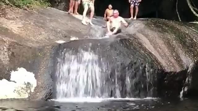 Old man fall from the waterfall.