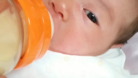 The baby is eating milk