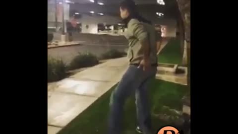 Guy tries to swing on street sign