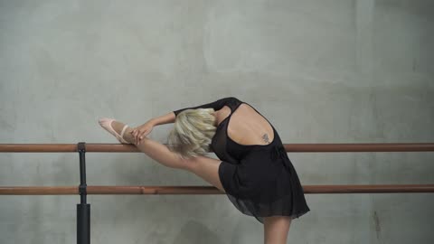 A Young Ballerina Stretching out Before her Performance