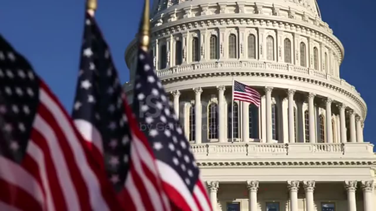 US Capitol dome with American flags in foreground