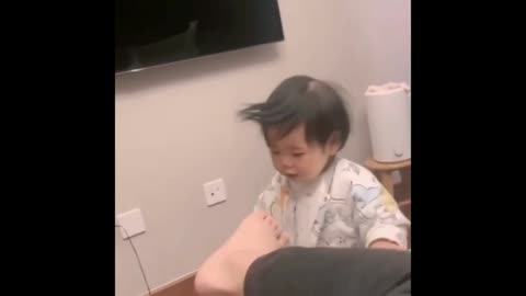 funny baby smells toe