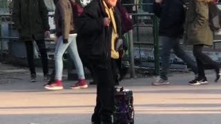 Man black jacket yellow shirt dancing with speaker