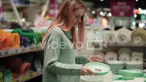 Woman Shopping Tableware, Choosing Plates In Supermarket