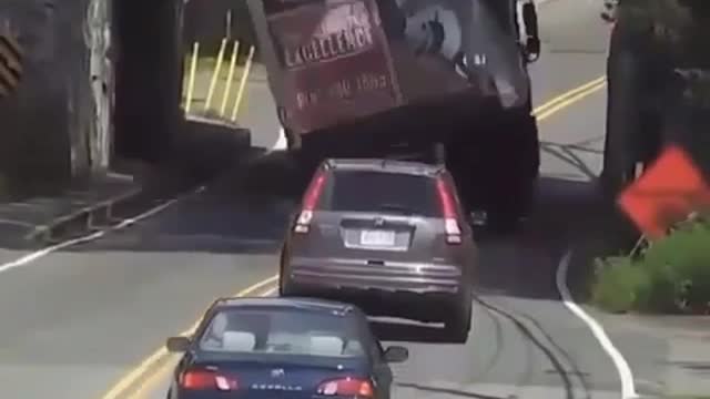 Truck carriage load passby the edge of bridge slams the entire load video