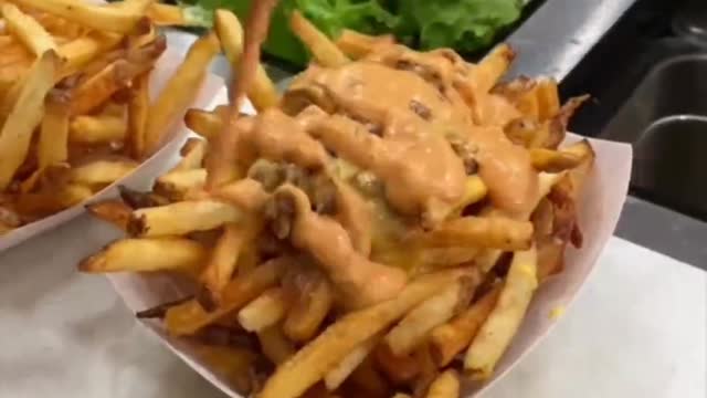 Freshly baked fries, crispy and delicious! Topped with a secret sauce!