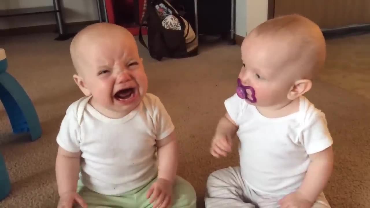 Twin baby girls fight over pacifier