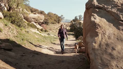 A Woman Walking Together with a Pet Dog