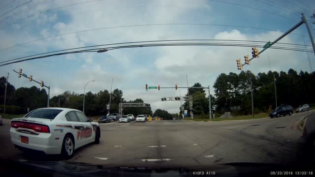 Driver Runs A Red Light In Front Of The Police