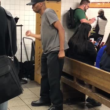 Guy black hat grey shirt dancing subway 14 street