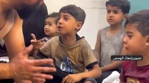 Palestinian Adults Work to Console Child Victims of IDF Bombing
