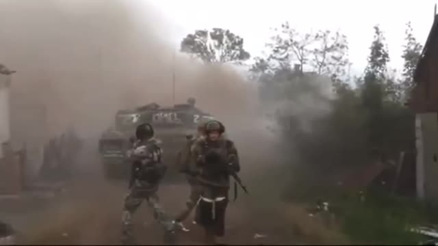 LPR troops supporting a tank