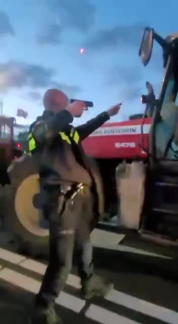 Dutch police going in hard on farmers with guns pointing at them.