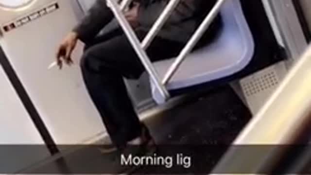 Man brown jacket smoking on train