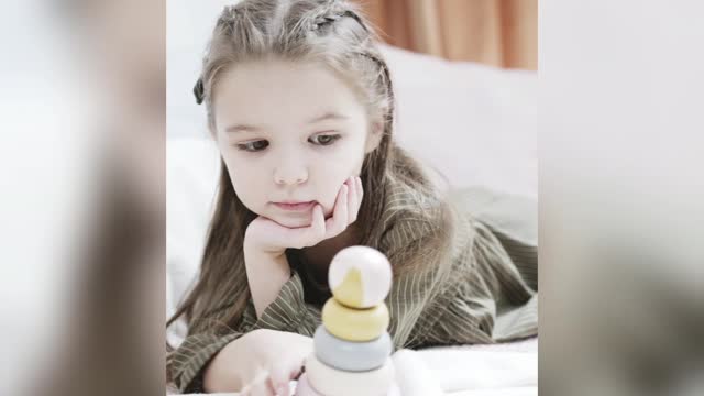 Cute Little Girl Playing With Her Wooden Toy