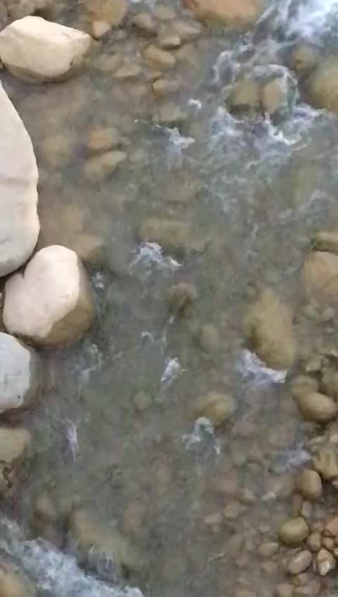 River in the middle of two mountain
