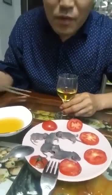Chinese man eats baby mice alive