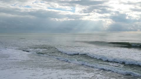 Watching the wave splashing the shores with the sound.