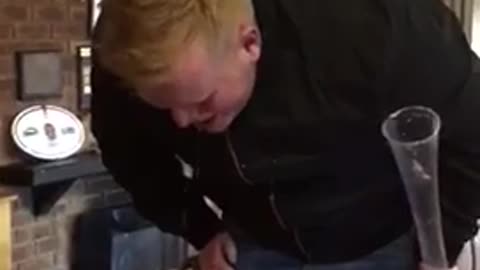 Guy black jacket drinking and throwing up
