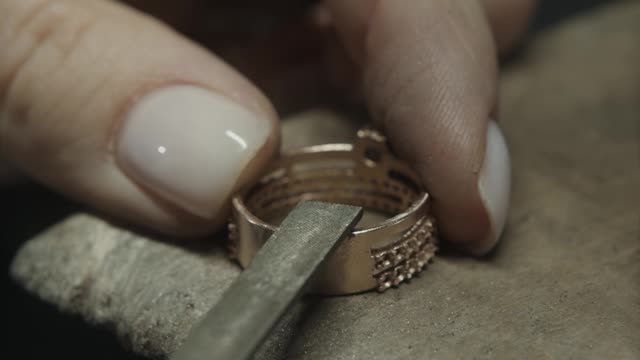 Close Up View of a Person Smoothing a Gold Ring