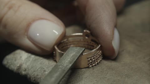 Close Up View of a Person Smoothing a Gold Ring