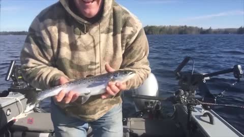 He caught the fish, but it jumped out of his hands right into the water