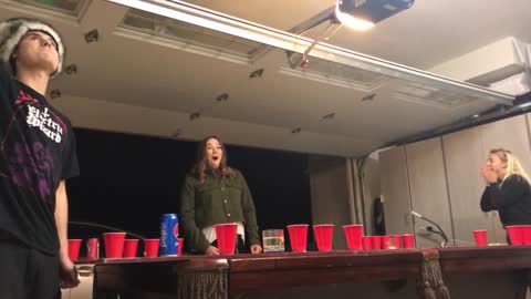 Beer pong expert catches ping pong ball in mouth and spits it across table into opponants cup