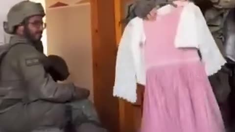 Israeli soldiers trying on Palestinian children’s clothes