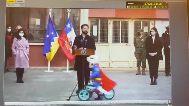 A Country's President Makes Speech, Child Cycles Around Him