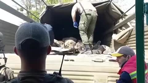 These shots show the Russian military burying their dead opponents