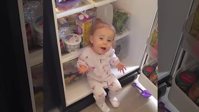 baby opens the fridge