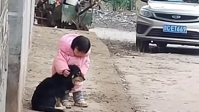 During the construction work , she covers the dog's ears, so that it isn't too loud for him