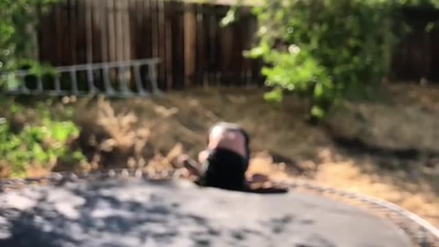 Man back flip on trampoline head stuck in hole