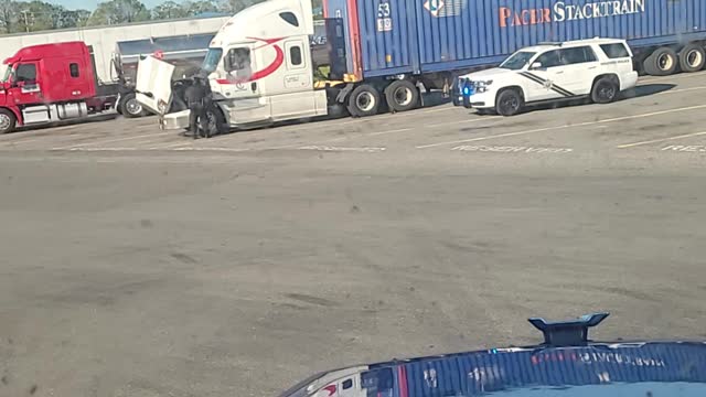 D.O.T. inspecting a driver at a truckstop