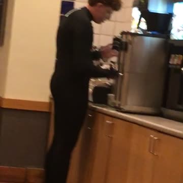 Guy in restaurant with full wetsuit