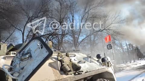 An armored personnel carrier under a red flag is fighting in the vicinity of Kharkov