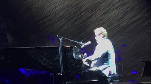 Elton John soaked to the bone