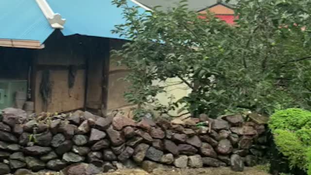 traditional house and wall in countryside of korea, rain dropped sliding from the roof