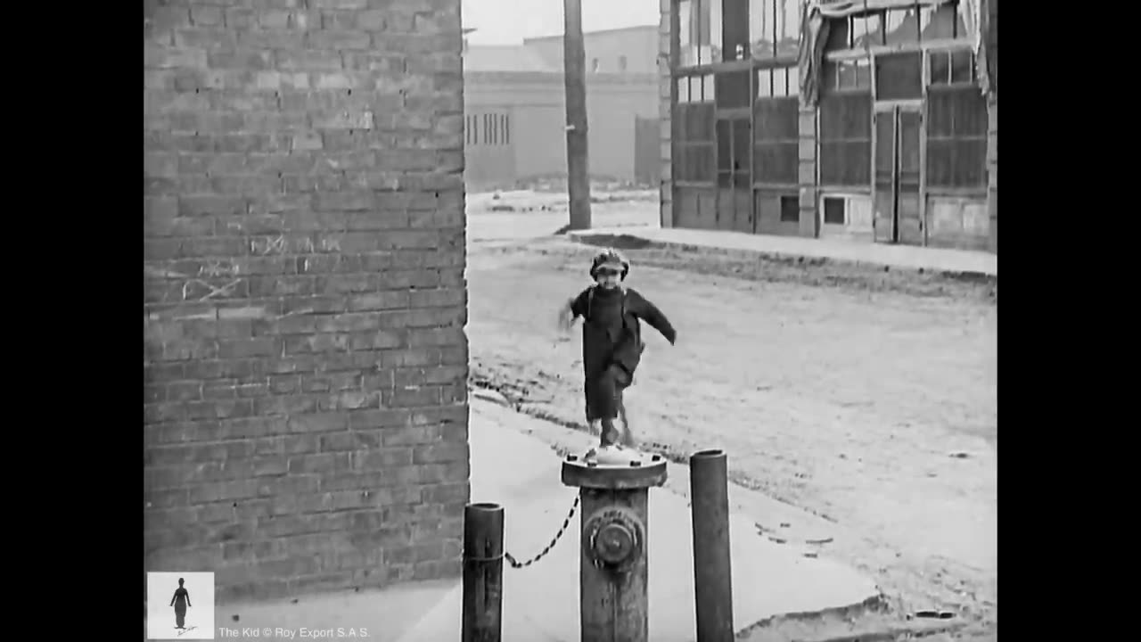 Charlie chaplin and kid working in streets