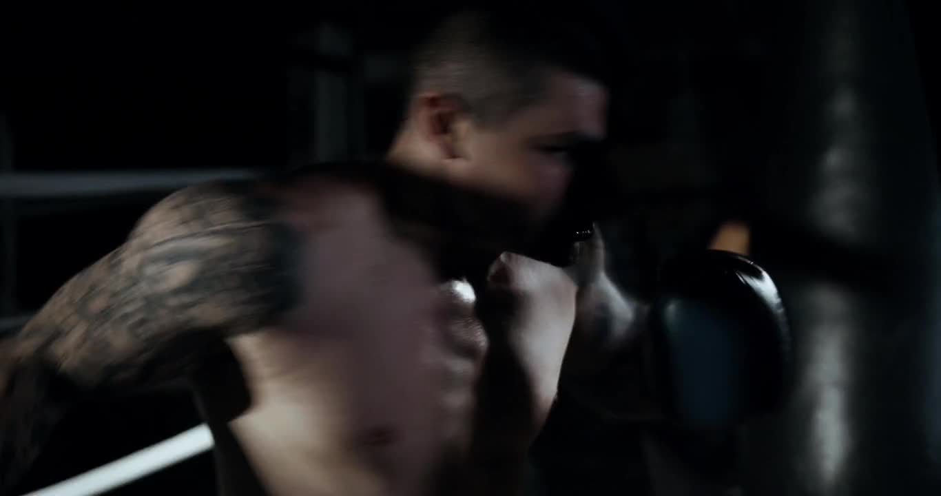 A Tattooed Man-Throwing Punches