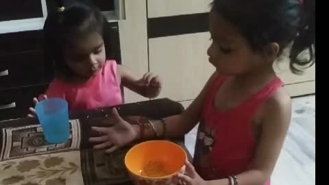 Elder sister share her meals with younger.