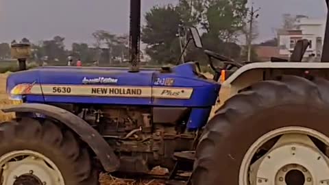 Farmer with New Holland Tractor