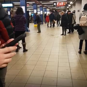 Zoom in on man dancing in subway station