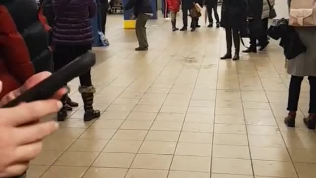 Zoom in on man dancing in subway station