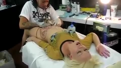 Crazy sexy girl doing tattoo on private part