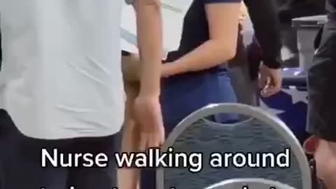 Nurse Walking Around Trying to Get People to Get the Jab