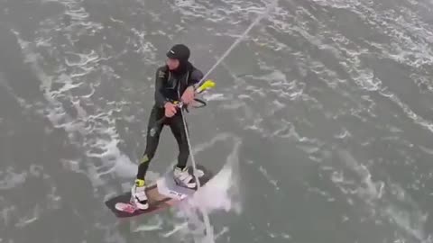 Guy kitesurfing falls down in water