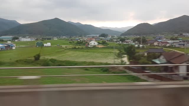 A view of a Korean farmhouse from the train